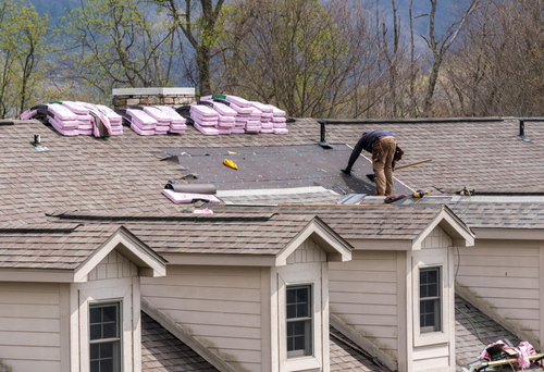 roofing contractor installing roofing shingles